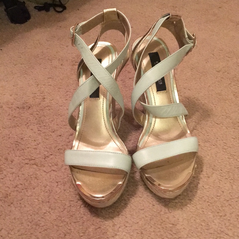 Sea foam green wedges with gold trim.